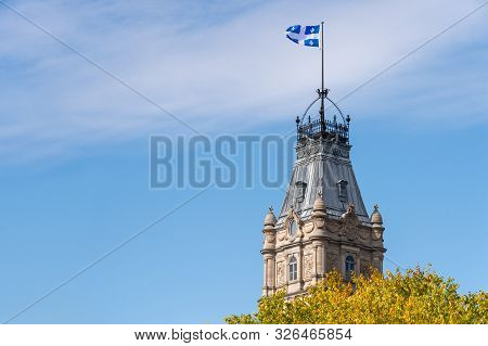 Quebec Flag At The Top Of The Quebec Parliament Building In Quebec City.
