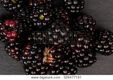 Lot Of Whole Fresh Black Blackberry Flatlay On Grey Stone