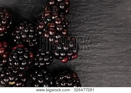 Lot Of Whole Fresh Black Blackberry Flatlay On Grey Stone