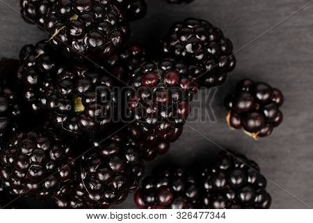 Lot Of Whole Fresh Black Blackberry Flatlay On Grey Stone