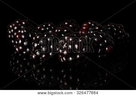 Lot Of Whole Fresh Black Blackberry Heap Isolated On Black Glass