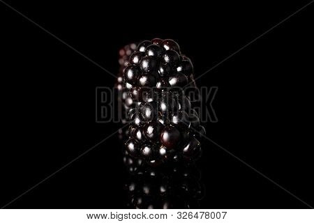 Group Of Two Whole Fresh Black Blackberry Isolated On Black Glass
