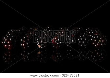 Lot Of Whole Fresh Black Blackberry Isolated On Black Glass