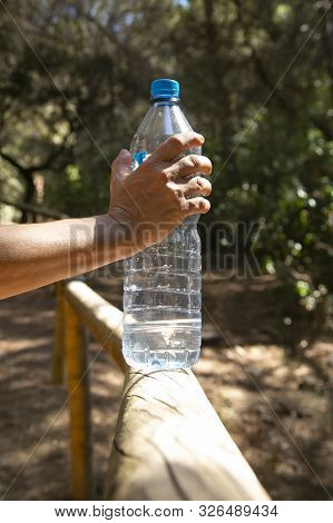 Hand Holding A Plastic Bottle With Water