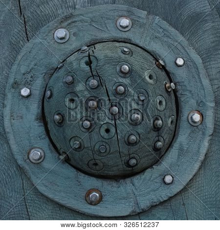 The Texture Of The Round Wooden Stylized Eye With Elements Of Metal Rivets And Screws Resembles The 