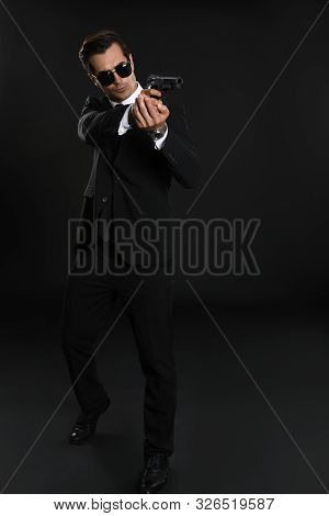 Male Security Guard In Uniform With Gun On Dark Background