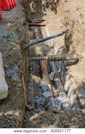 Old Leaky Pipes In The Pit. Preparation For Pipe Replacement.