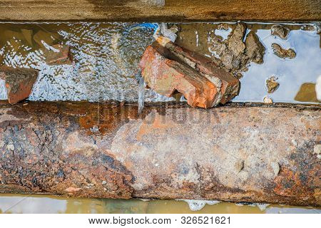 Old Leaky Pipes In The Pit. Preparation For Pipe Replacement.