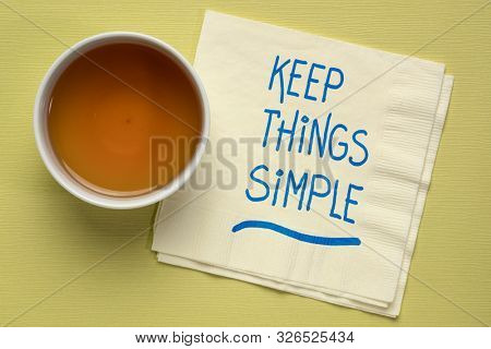 keep things simple - handwriting on a a napkin with a cup of tea, simplicity,  minimalism or lifestyle concept