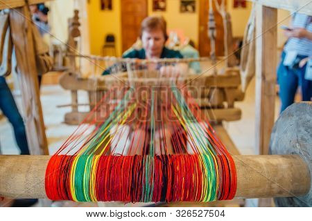 Woman Works With Traditional Hand Weaving Loom