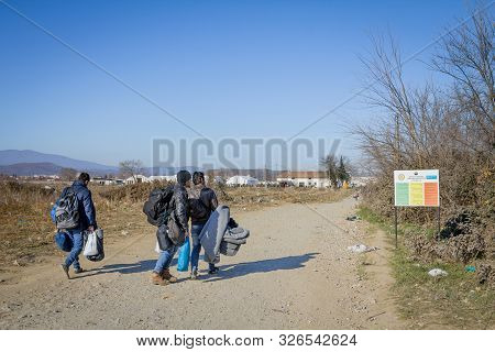 Gevgelija, Macedonia - December 13, 2015  Refugees Standing At The Entrance Of Vinojug Camps Near Th