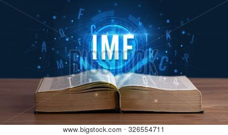 IMF inscription coming out from an open book, digital technology concept