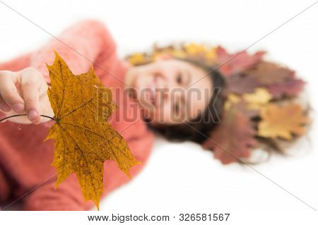 Take It. Child Giving Leaf Close Up. Girl Cute Kid Long Hair Lay On White Background With Fallen Lea