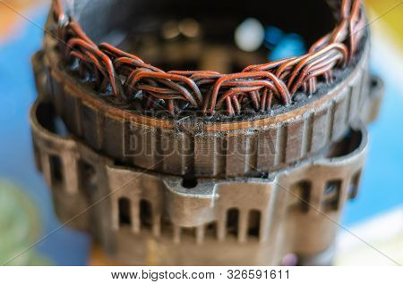 Close-up Of A Dirty Stator Of A Disassembled Car Generator. Selective Focus. Side View. Eye Level Sh