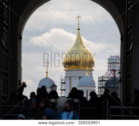 Tourists Pass Through The Spasskaya Tower Of The Moscow Kremlin