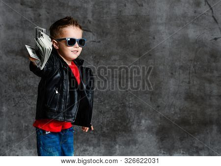 Generous Rich Kid Boy Millionaire Spender In Sunglasses, Leather Jacket And Red T-shirt Handing Us A