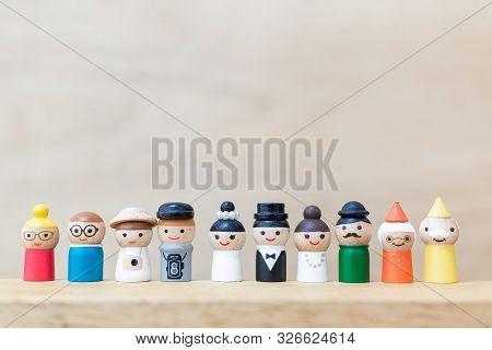Wooden Doll With  Happy Face On Wooden Background.