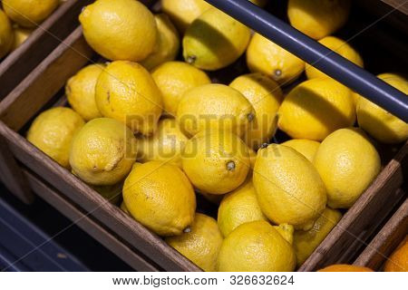 Many Wooden Lug Boxes With Fresh And Brigh Yellow Lemons Rich In Vitamins