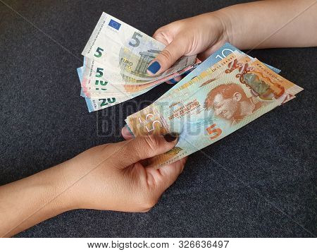 Women Hands Exchanging European Banknotes And New Zealand Money