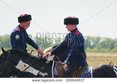 Samara, Russia - August 17, 2019: Young Cossacks In Traditional Costumes On Horseback