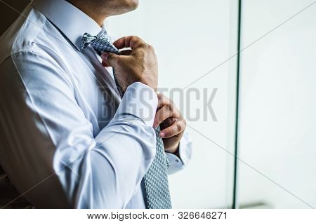 Businessman Making A Tie Knot, Formal Suit