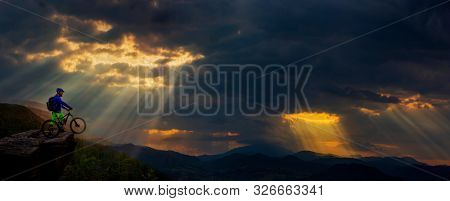 Cycling man riding on bike at sunset mountains forest landscape. Cycling MTB enduro flow trail track. Outdoor sport activity.