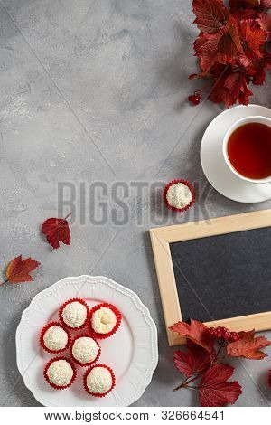 Blackboard With Autumn Red Leaves, Candies And Tea On Gray Table. Top View, Space For Text. Teacher'