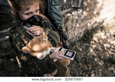 Selective Focus Of Kid In Gas Mask Holding Radiometer, Post Apocalyptic Concept