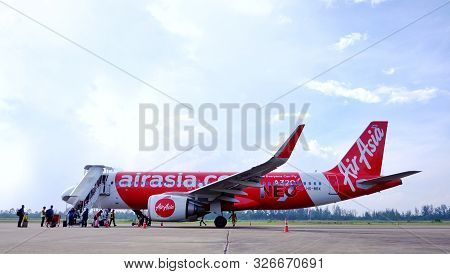 Chumphon, Thailand - October 09,2019 : Thai Air Asia At Chumphon Airport With Passengers Walking Aro