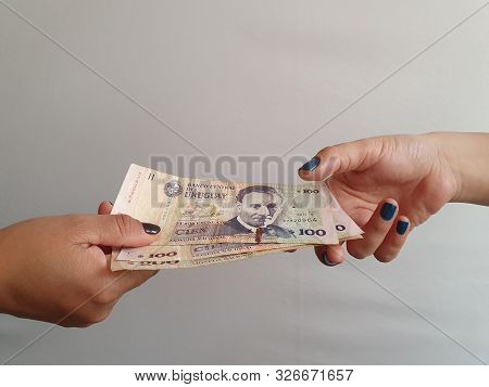Women Hands Paying And Receiving Uruguayan Money