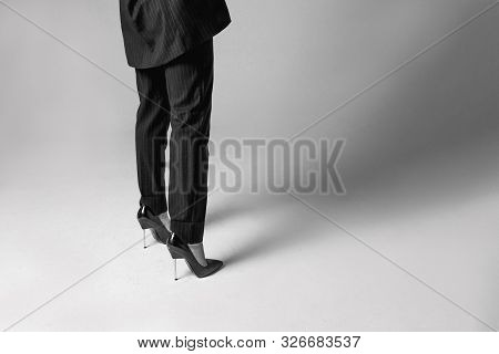 Fashionable Women's Pumps And Classic Striped Pantsuit. Young Woman Legs In Black Elegant Shoes.styl