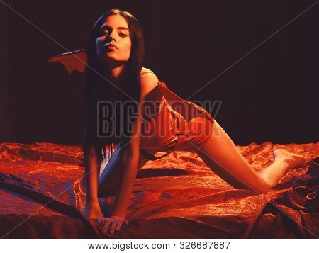 Temptress Concept. Lady Sexi Dressed As Demon, Devil, Black Background. Demon Sexy Girl Crawl On Sil