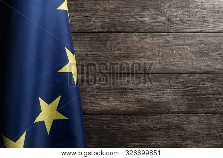The European Flag Hanged Against Wooden Wall Background