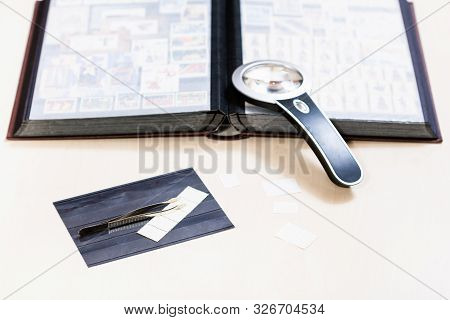 Philately Background - Still Life From Stamp Collecting Items On Pale Wooden Table