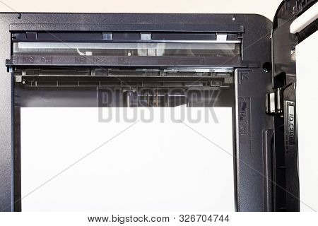 Top View Of Sheet Of Paper On Glass Of Scanner In Multi Function Device On Table In Office