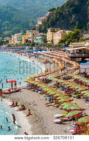 Monterosso Al Mare, Italy - September 02, 2019: The Famous Beach Full Of Deckchairs, Sun Umbrellas P