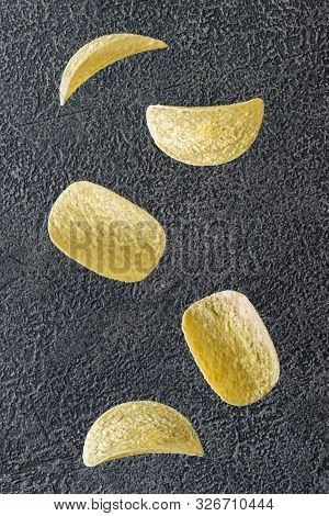 Potato Chips On The Black Background
