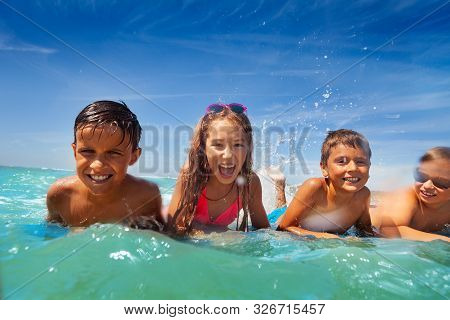 Group Of Kids Lay In Sea Water Swim And Splah