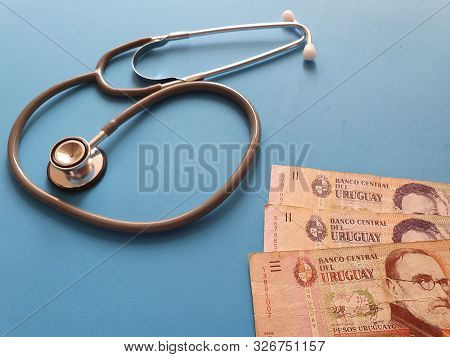 Investment In Health Care, Uruguayan Money And Stethoscope For Medical Check