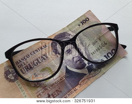 Investment And Promotion For A Better Vision, Uruguayan Banknote Of 100 Pesos And Black Plastic Fram