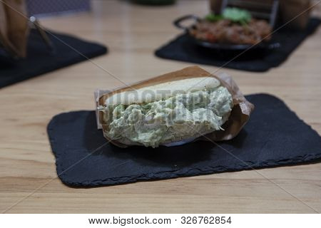 Pepiada Arepa Stuffed Cucumber With Sauce, Traditional Latin Cuisine On Stone Plate