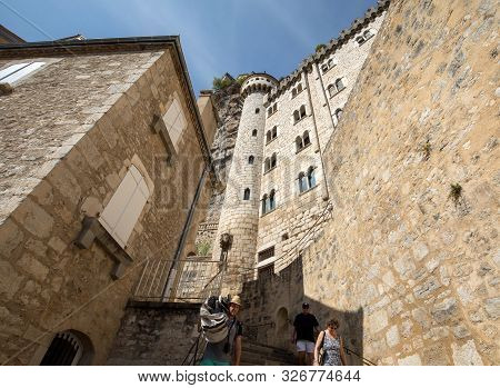 Rocamadour, France - September 3, 2018: Stone Walls Of Historic Basilica Of St-sauveur Blend Into Th