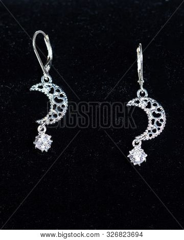 A Pair Of Silver Cresent Shaped Pendant Earrings