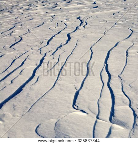 Narrow Elongated Ridges Of Snow Across The Wind. Landform Background.