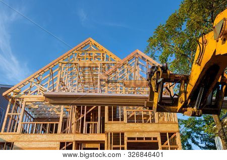 Heavy Boom Truck Machinery Is Used To Add The Roof Trusses To A Timber Frame House Extension Constru
