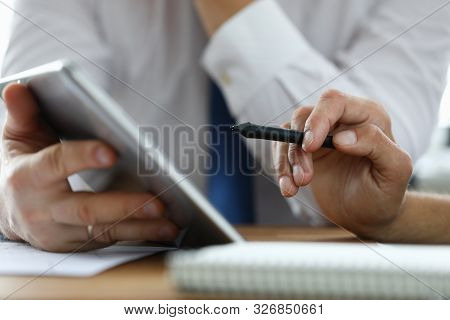 Focus On Male Hand Holding Stylos. Colleague With Modern Tablet Explaining Conditions Of Contract. B