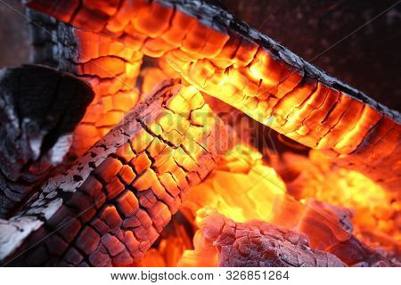 Close-up Of Burning Log In Bonfire. Large Orange Flame From Fire With Woods. Light And Ash From Wood
