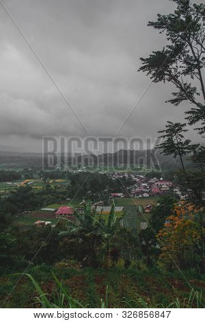 Foggy Country Which Is Located At The Foot Of Mount Singglang Where There Are People Gardening And L