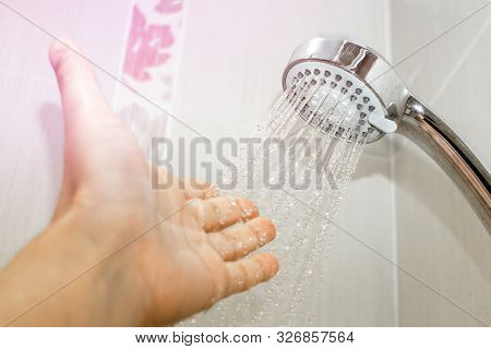 Check The Temperature Of The Water In The Shower. Water Supply Problems In The City. Taking A Shower