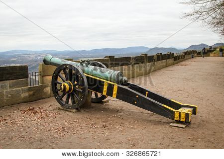 An Antique Cannon On A Lafette In A Castle